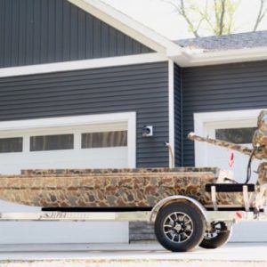 Camo patterned mud boat and mud motor for hunting