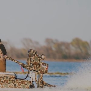 camo boat and mud motor being driven on Minnesota lake
