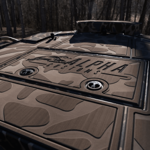 Camo deck of mud boat with Alpha Customs logo engraved