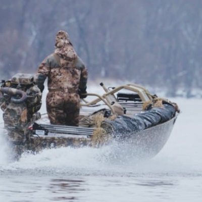 man wearing camo hunting with Alpha Customs boat